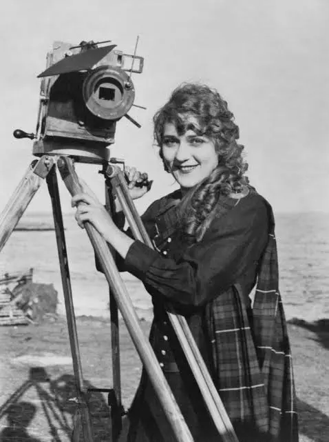 Mary Pickford behind a film camera on tripod