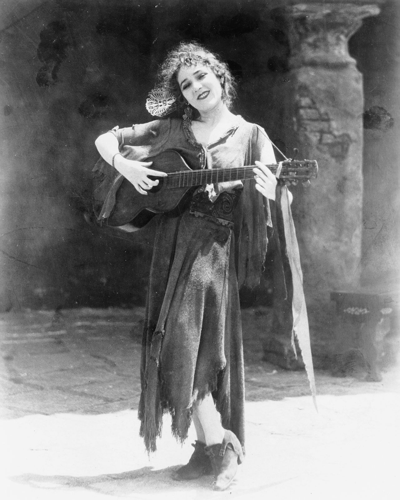 Mary Pickford in costume holding a guitar
